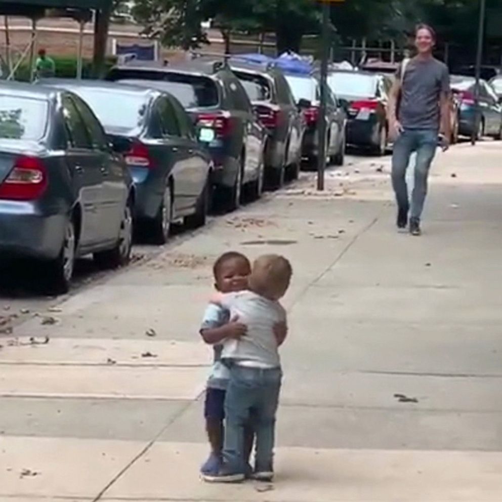 PHOTO: Two-year-old best friends, Finnegan and Maxwell, embrace on the street in the screen grab from viral video.