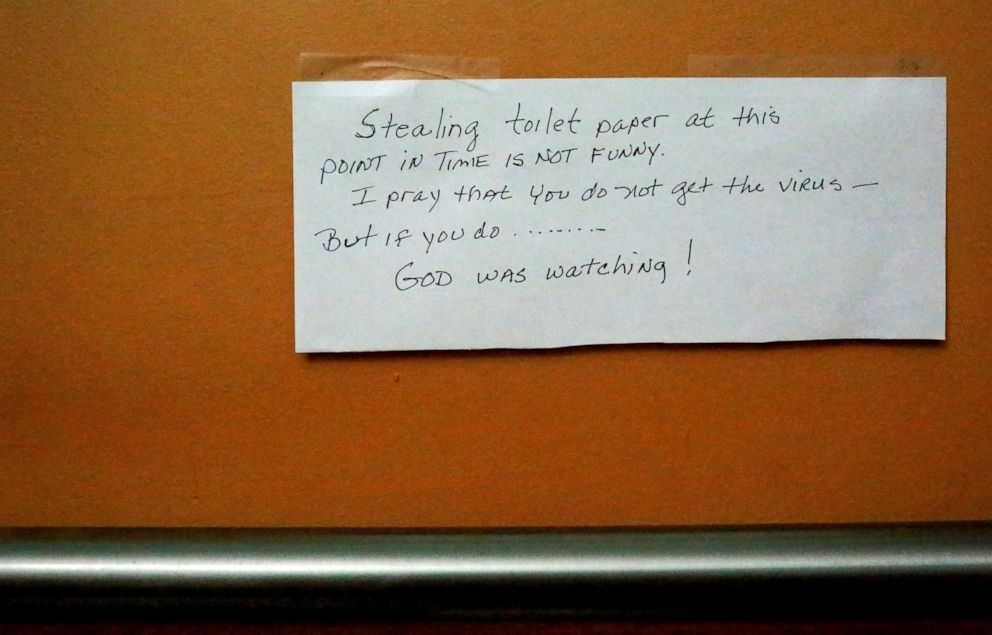 PHOTO: A note warning against stealing toilet paper hangs in the bathroom of Flip Flops II internet cafe, which is experiencing a decrease of patrons amid the coronavirus outbreak, in The Villages, Fla., March 16, 2020.