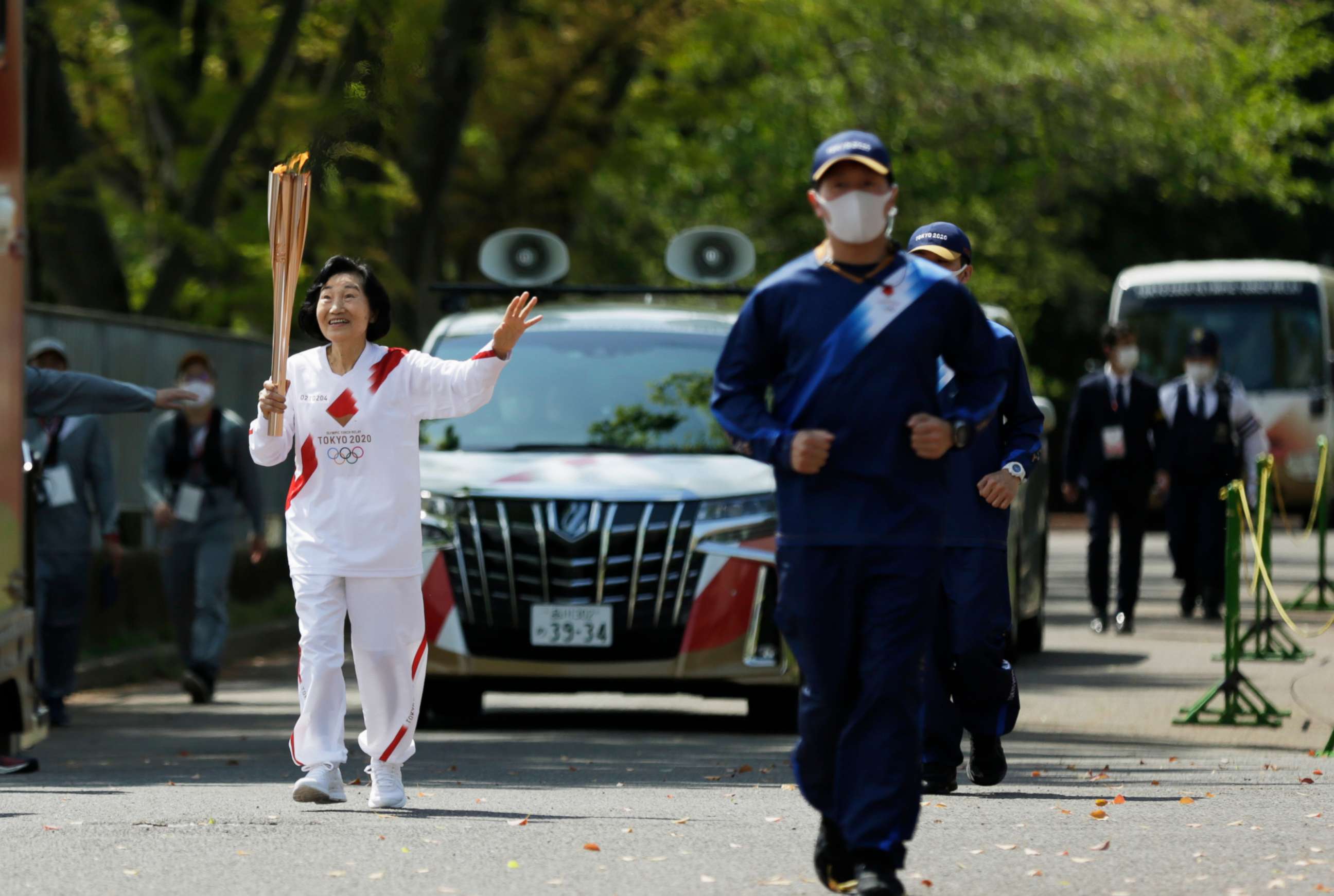 PHOTO: An Olympic torch relay runner carries the torch on the second day of the Osaka leg in Suita, north of Osaka, western Japan, April 14, 2021.