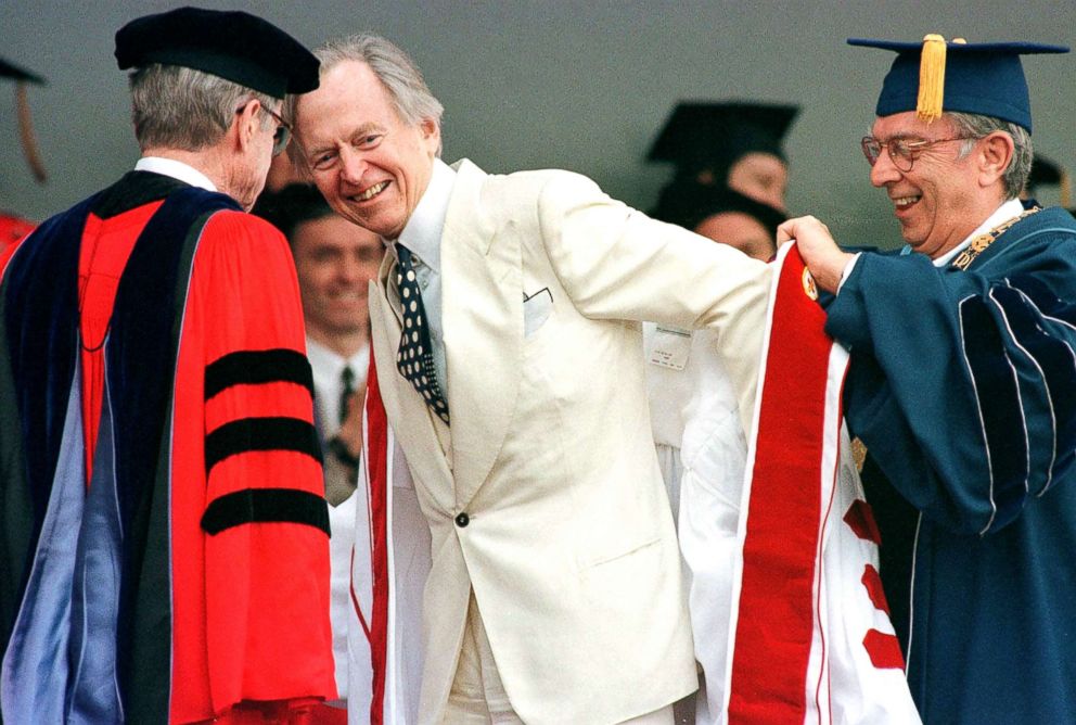 PHOTO: Author Tom Wolfe recieves a white robe as part of his honorary degree from Boston University Chancellor John Silber, left, and university President John Westling during commencement exercises in Boston, May 21, 2000.