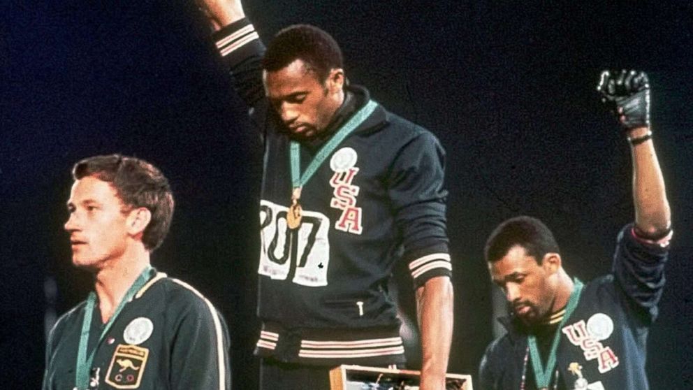 PHOTO: Athletes Tommie Smith, center, and John Carlos stare downward during the playing of "The Star-Spangled Banner" after Smith received the gold and Carlos the bronze medal in the 200 meter run at the Summer Olympic Games in Mexico City. 