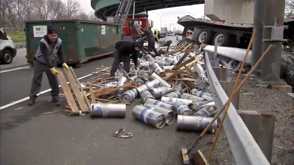 PHOTO: Crews work to remove hundreds of empty beer kegs and containers littered I-95 on Bensalem, Bucks County, PA, April 10, 2018, after a trucked plunged more than 20 ft.