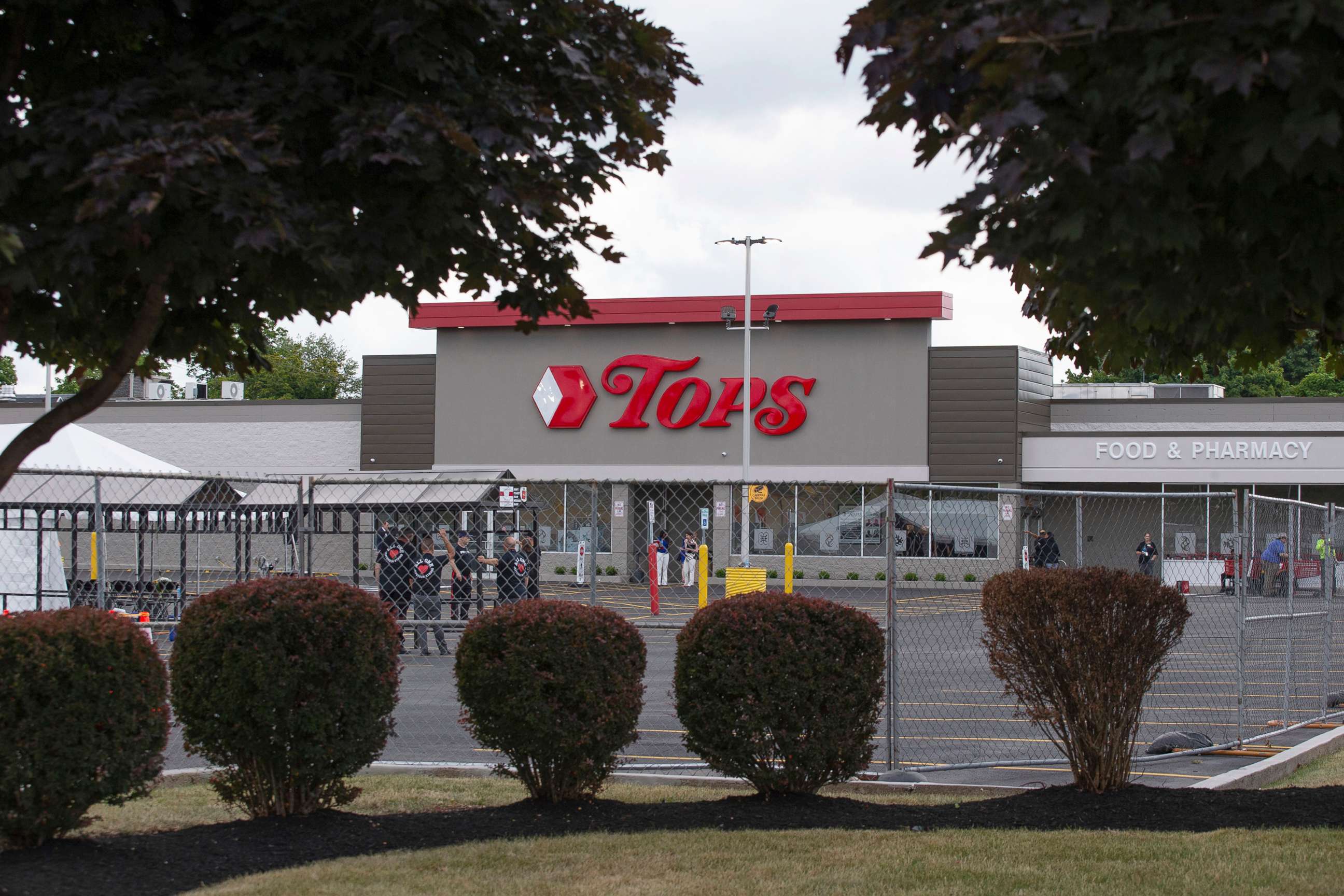 PHOTO: People work in the parking lot of the Tops Friendly Market, July 14, 2022, in Buffalo, N.Y. 