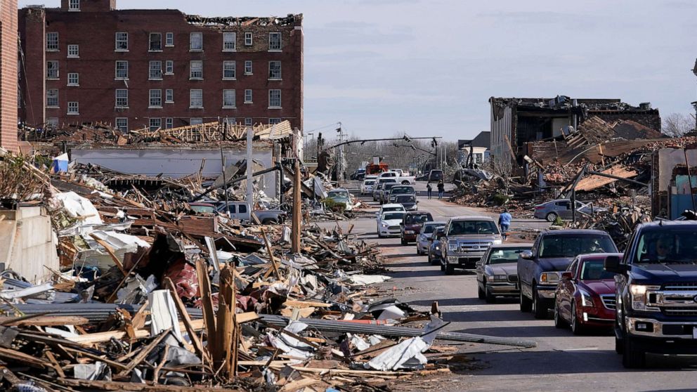 PHOTO: People survey the damage after a tornado hit Mayfield, Ky., Dec. 11, 2021. 