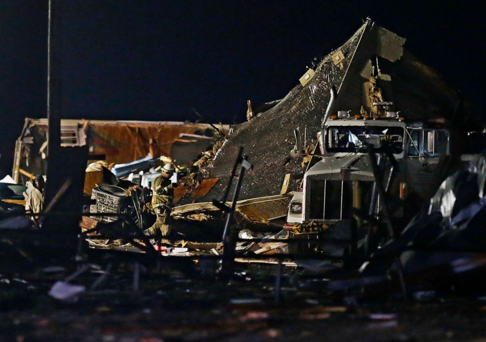 PHOTO: Emergency workers search through debris from a mobile home park, May 26, 2019, in El Reno, Okla., following a tornado. 