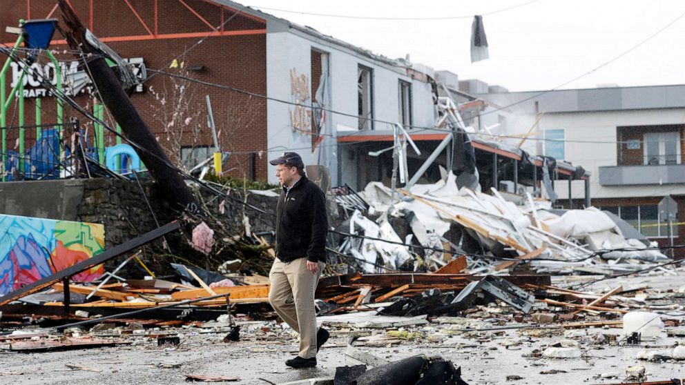 PHOTO: A man walks past storm debris following a deadly tornado, March 3, 2020, in Nashville, Tenn.