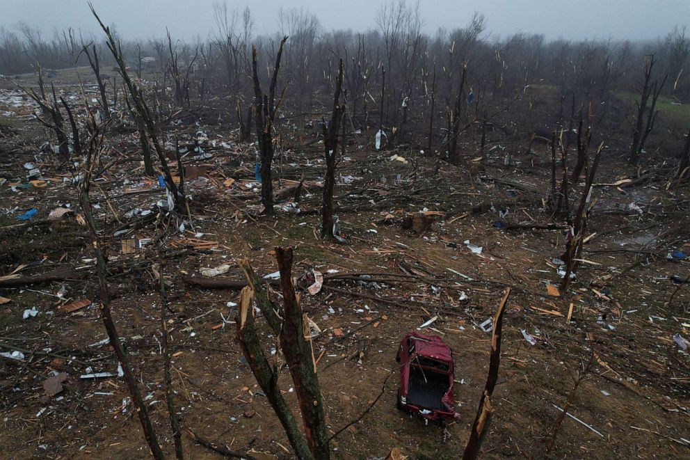 PHOTO: A truck is seen amongst debris which was swept into a forested area behind homes, following a devastating outbreak of tornadoes that ripped through several U.S. states, in Mayfield, Ky., Dec. 17, 2021.