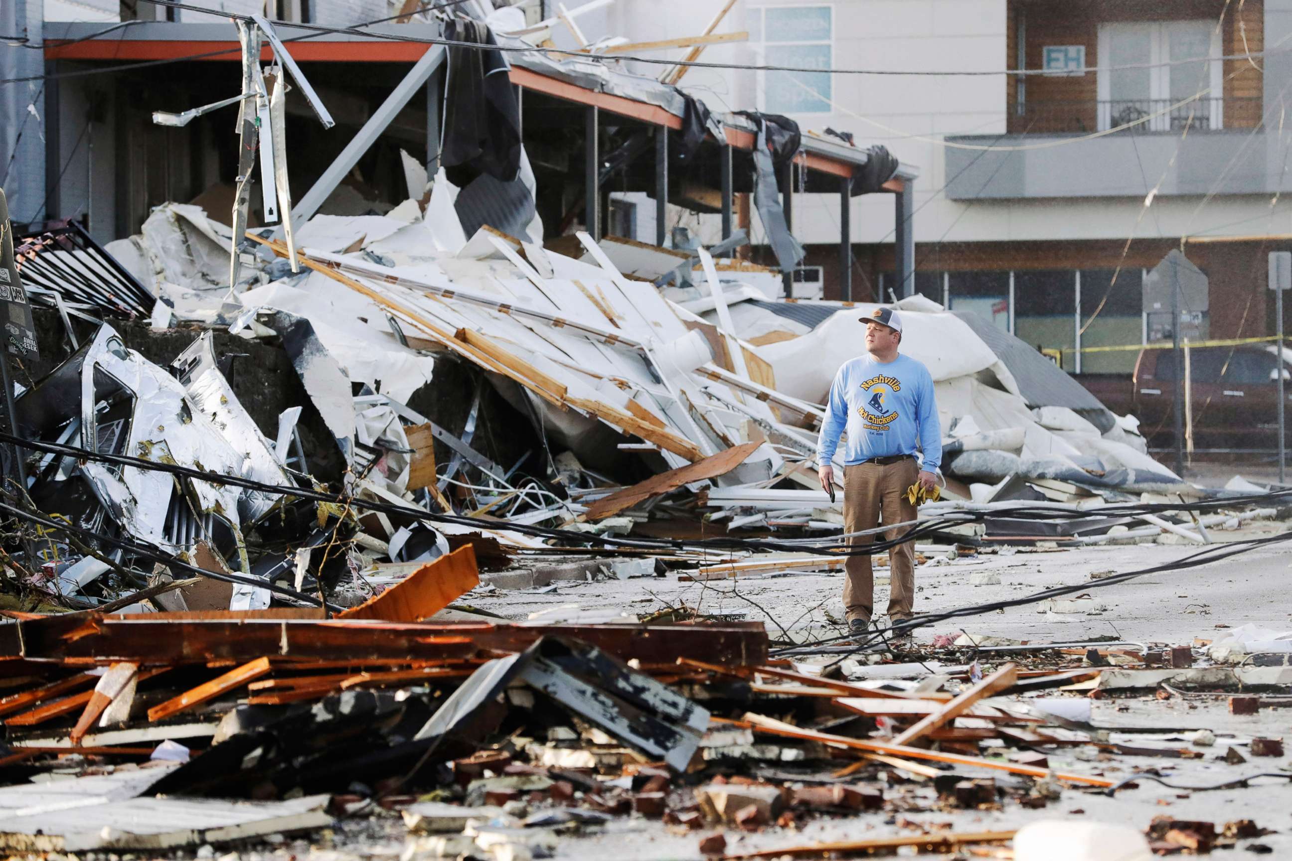 PHOTO: A man looks over buildings destroyed by storms, March 3, 2020, in Nashville, Tenn.