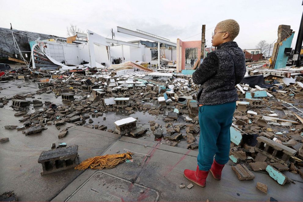 PHOTO: Faith Patton looks over buildings destroyed by storms, March 3, 2020, in Nashville, Tenn. 