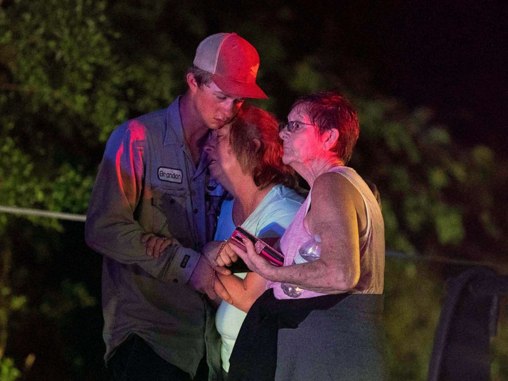 PHOTO: People embrace after an apparent tornado touched down, April 22, 2020, in Onalaska, Texas.