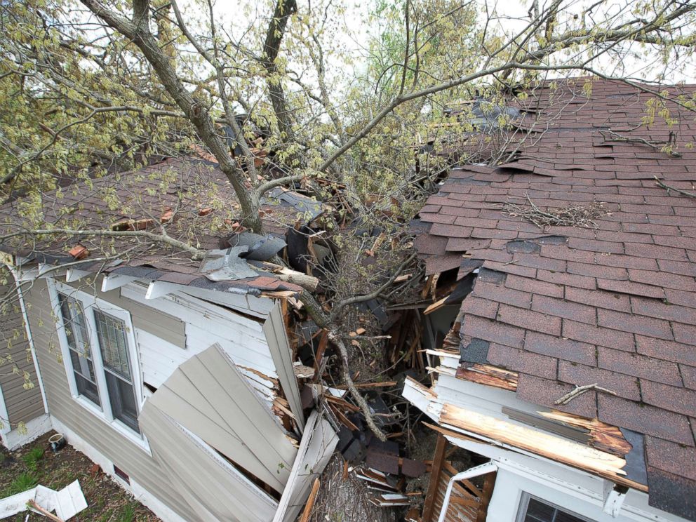 PHOTO: A tree cleaves the house on Oak Grove Avenue the day after a tornado hit, killing one person and leaving devastation throughout eastern portion of the city, April 16, 2018, in Greensboro, N.C.