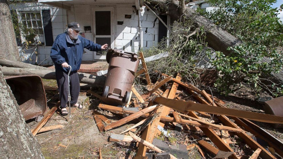 PHOTO: David Oldham, on Oak Grove Avenue, stands amid wreckage the day after a tornado sent a tree crashing into his house, April 16, 2018, in Greensboro, N.C.