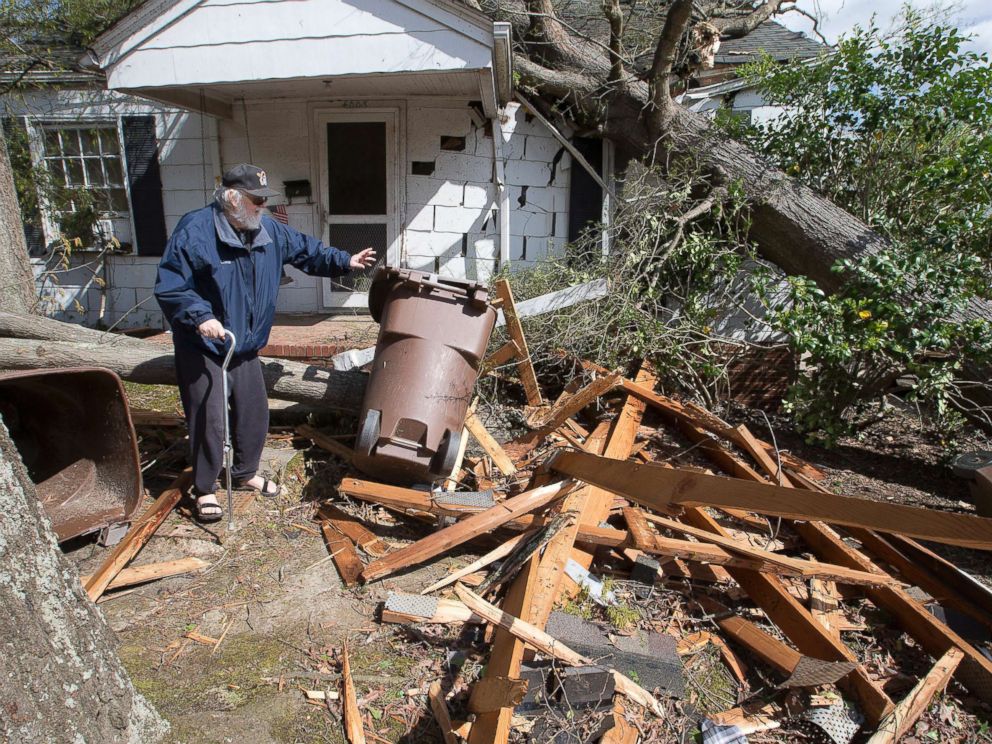 PHOTO: David Oldham, on Oak Grove Avenue, stands amid wreckage the day after a tornado sent a tree crashing into his house, April 16, 2018, in Greensboro, N.C.
