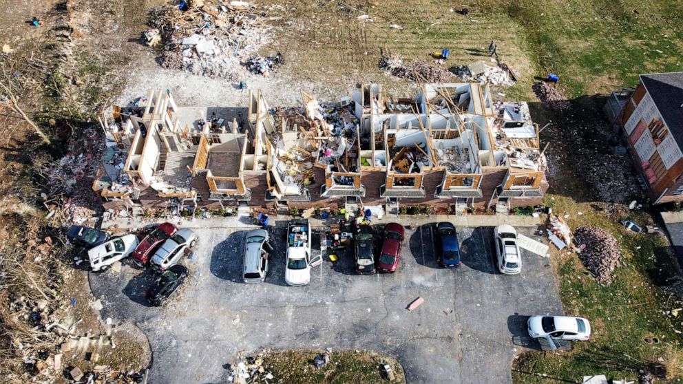 PHOTO: People clear belongings and debris from a line of townhomes destroyed by the Dec. 11 tornadoes on Hillridge Court in Bowling Green, Ky., Dec. 15, 2021.