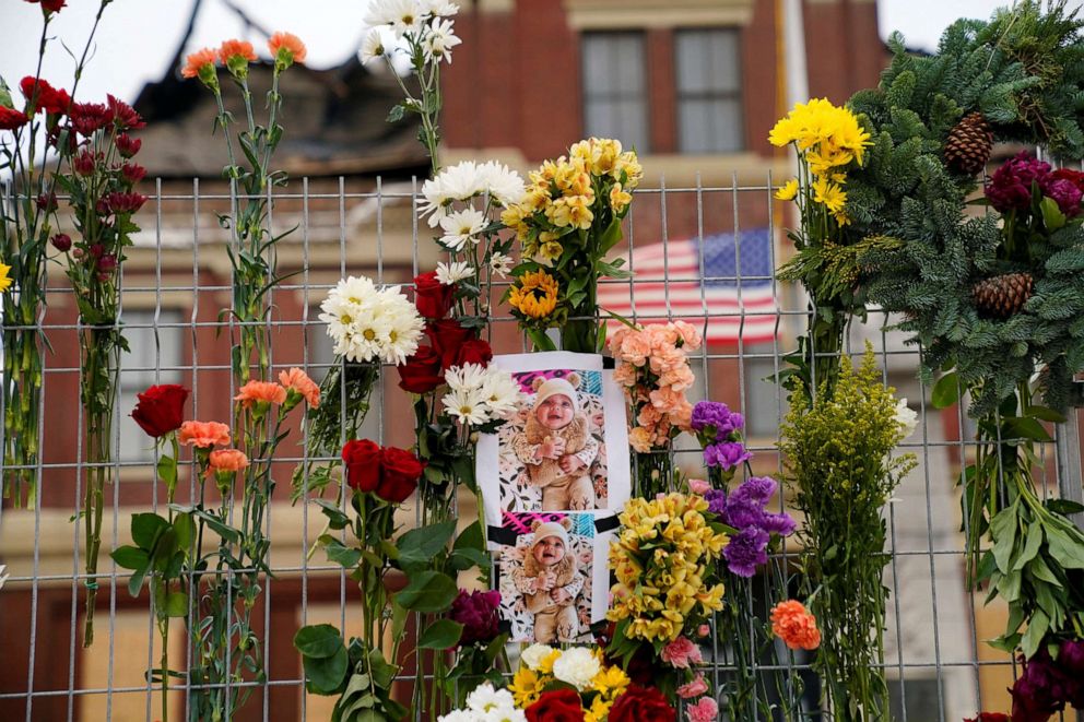 PHOTO: Photographs of Oaklynn Koon, who died as a result of injuries sustained during the storm, are seen attached to a fence at the site of a memorial for tornado victims outside of town hall in Mayfield, Ky., Dec. 15, 2021.