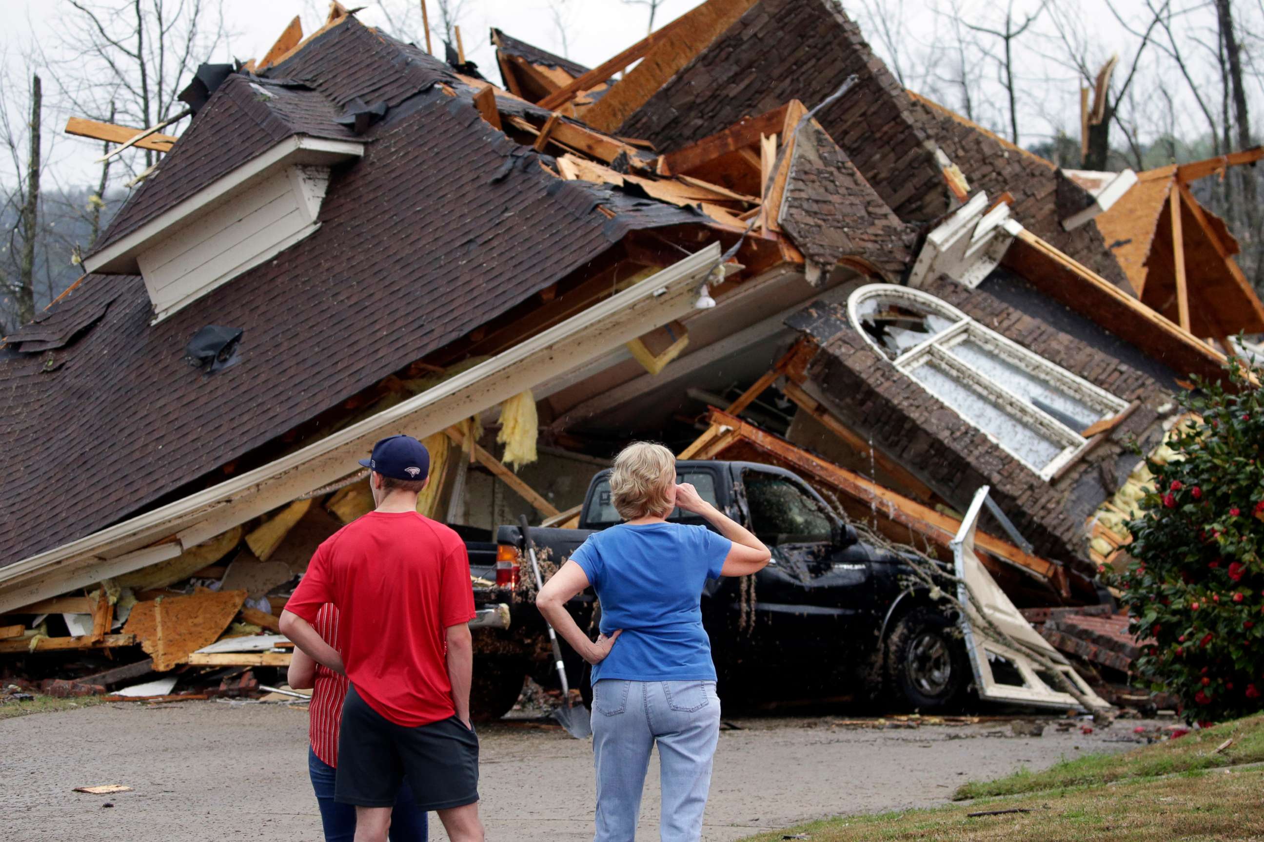 PHOTO: Residents survey damage to homes after a tornado touches down south of Birmingham, Ala. in the Eagle Point community damaging multiple homes, March 25, 2021.