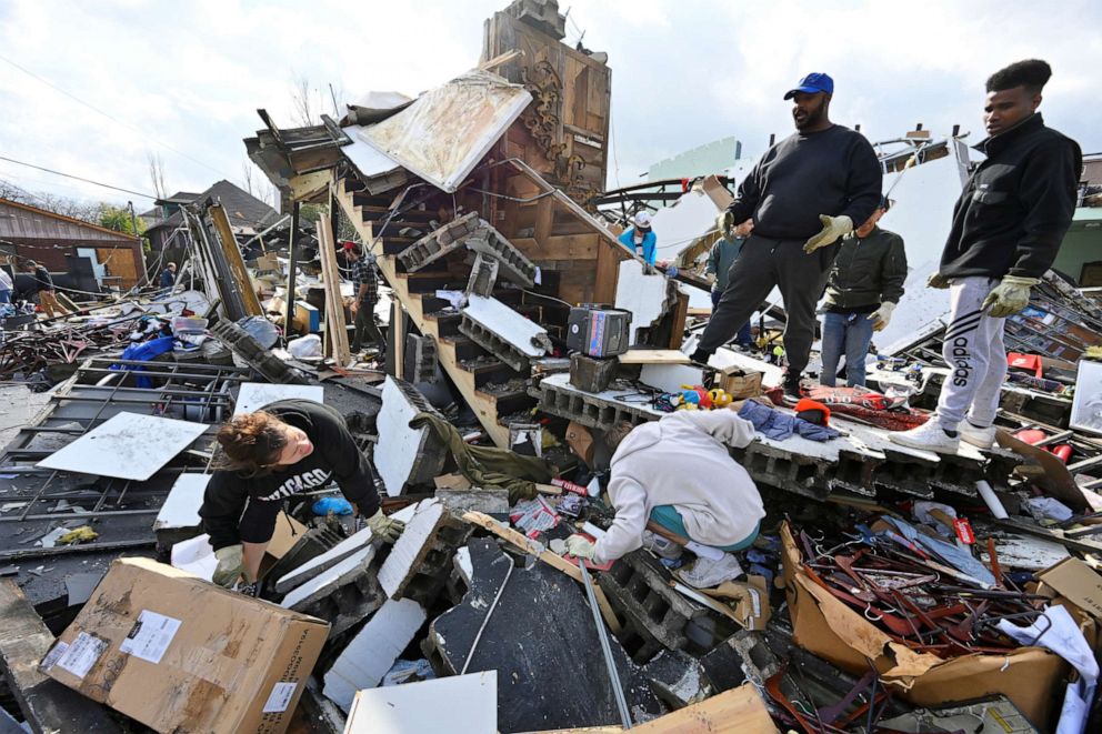 PHOTO: People try to salvage merchandise at Music City Vintage after a tornado hit eastern Nashville, Tennessee, March 3, 2020.