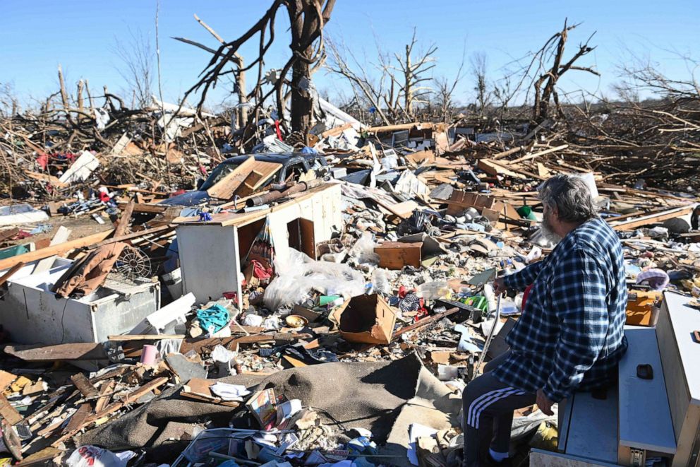 PHOTO: A man surveys tornado damage after extreme weather hit the region Dec. 12, 2021, in Mayfield, Ky.