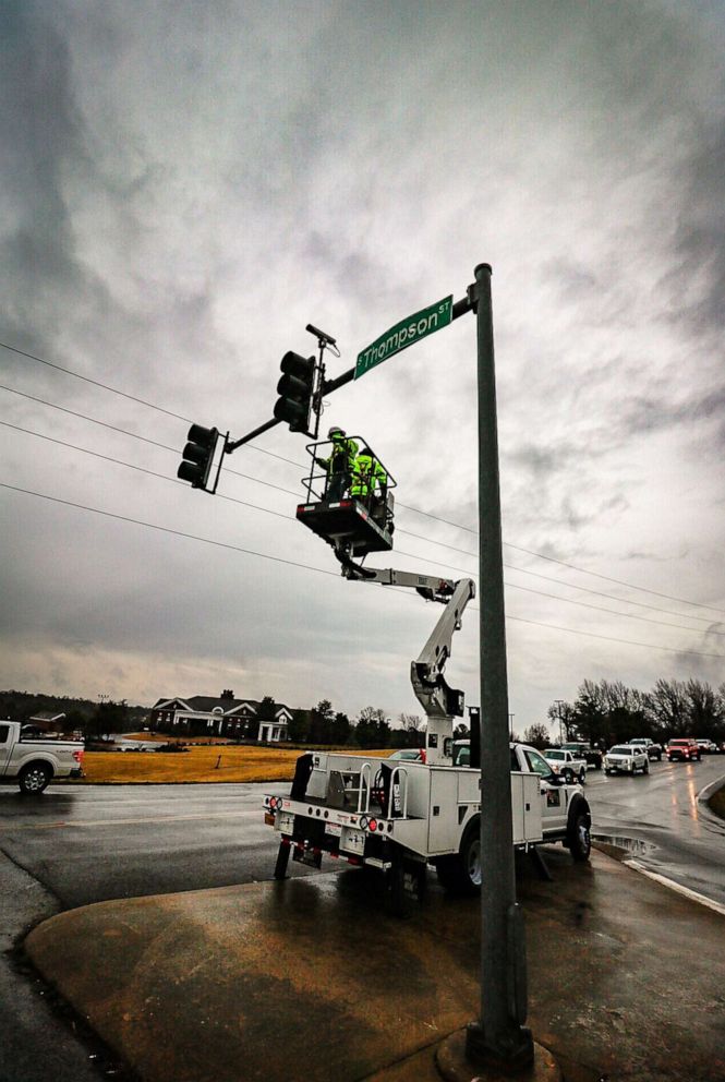 PHOTO: Crews worked to fix traffic lights on Thompson Street in after a tornado touched down in the area Springdale, Ak., March 30, 2022.