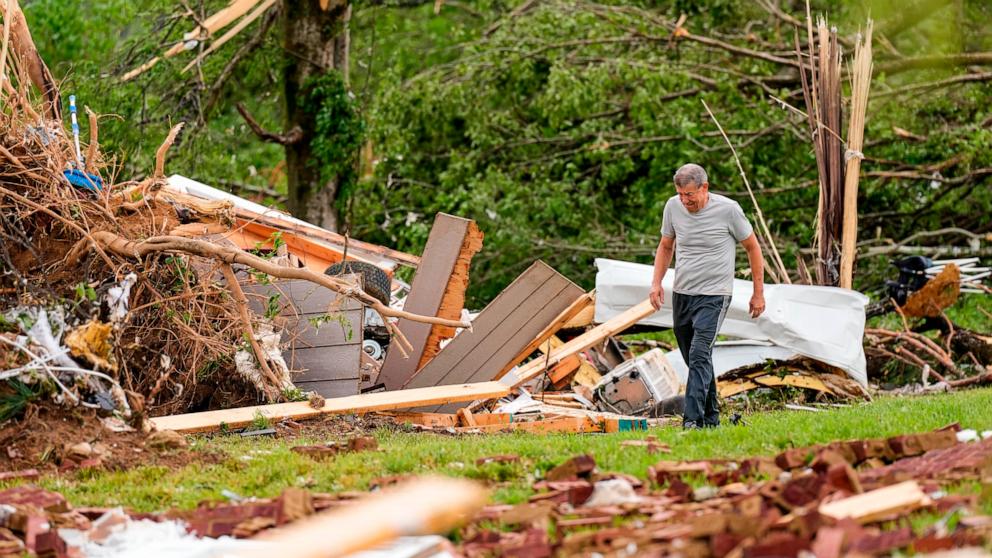 PHOTO: John Bernhardt searches for his belongings outside his storm-damaged home Thursday, May 9, 2024, in Columbia, Tenn. 