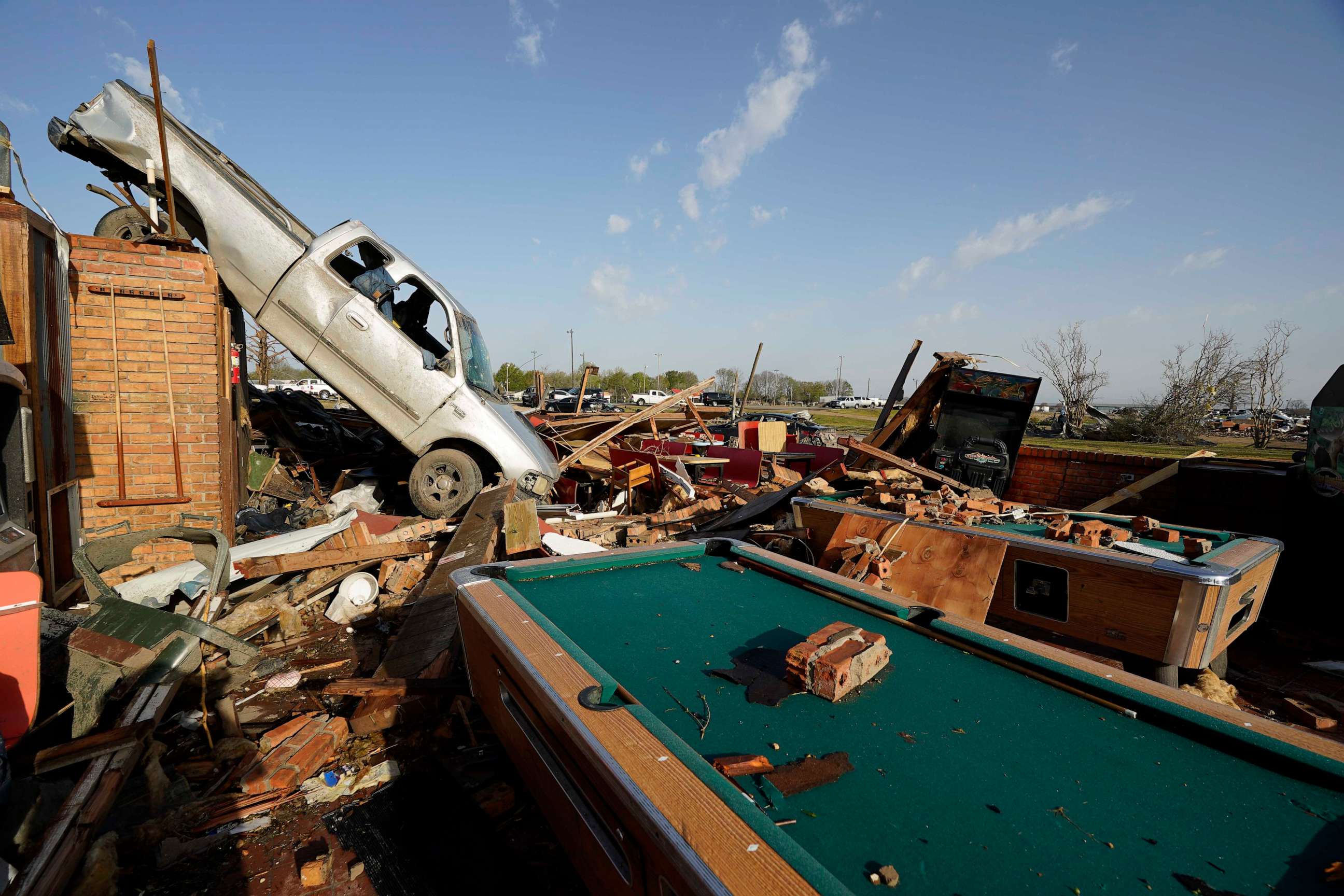 PHOTO: A pickup truck rests on top of a restaurant cooler at the tornado demolished Chuck's Dairy Cafe in Rolling Fork, Miss., Mar. 25, 2023.
