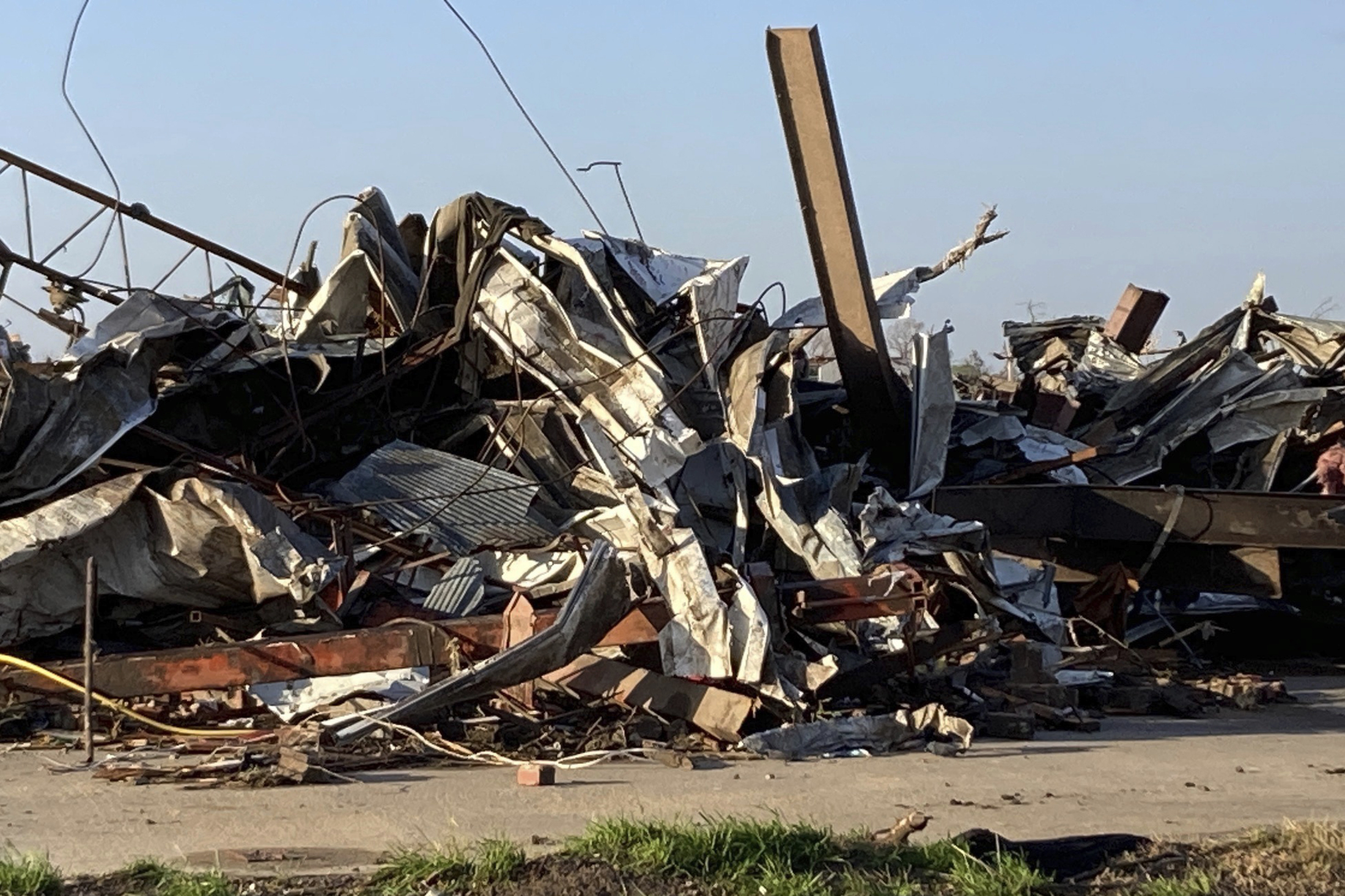 PHOTO: Debris from a tornado covers a damaged structure, March 25, 2023, in Rolling Fork, Miss.