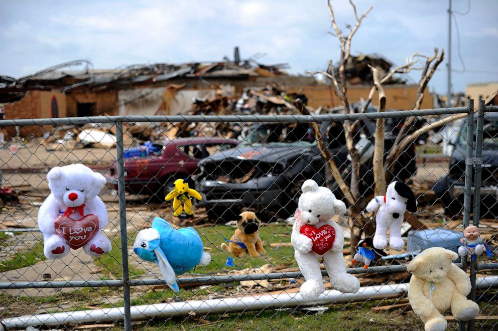 PHOTO: Toys and crosses adorn a makeshift memorial on the grounds of the Plaza Towers elementary school in memory of the seven children who died during the devastating tornado, in Moore, Okla., on May 25, 2013.