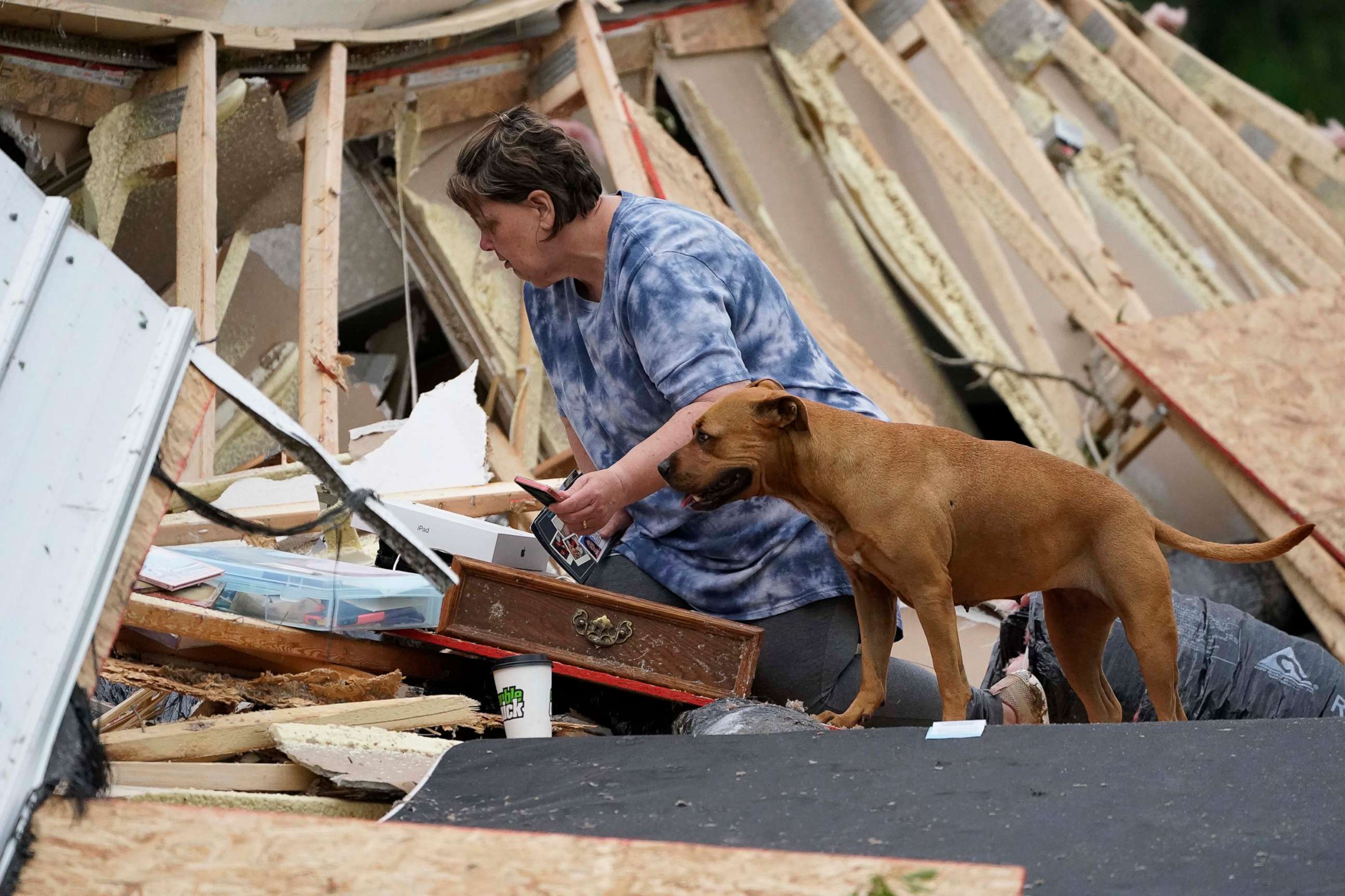 PHOTO: Vickie Savell looks through her belongings amid the remains of her new mobile home, May 3, 2021, in Yazoo County, Miss.