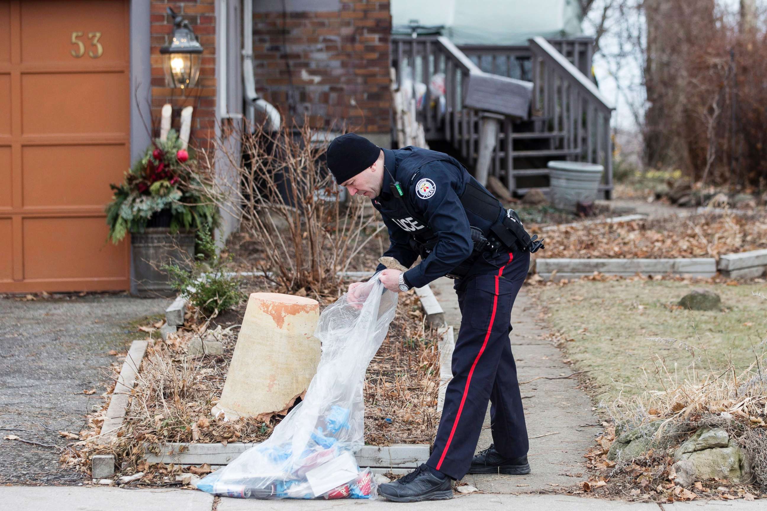 PHOTO: A police officer investigates outside a house on Mallory Crescent in Toronto, Jan. 29 , 2018.