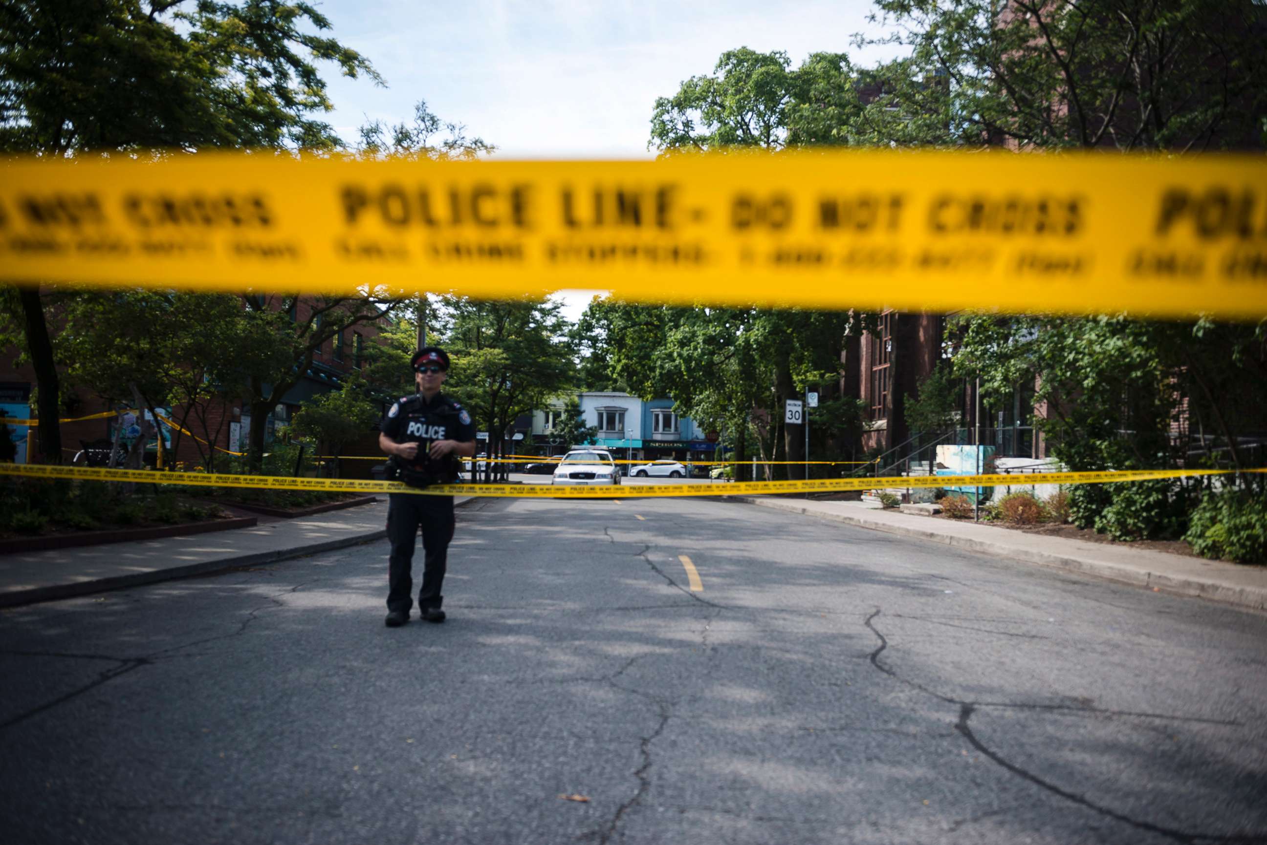 PHOTO: Police are photographed at the perimeter of the scene of a mass shooting in Toronto on July 23, 2018.