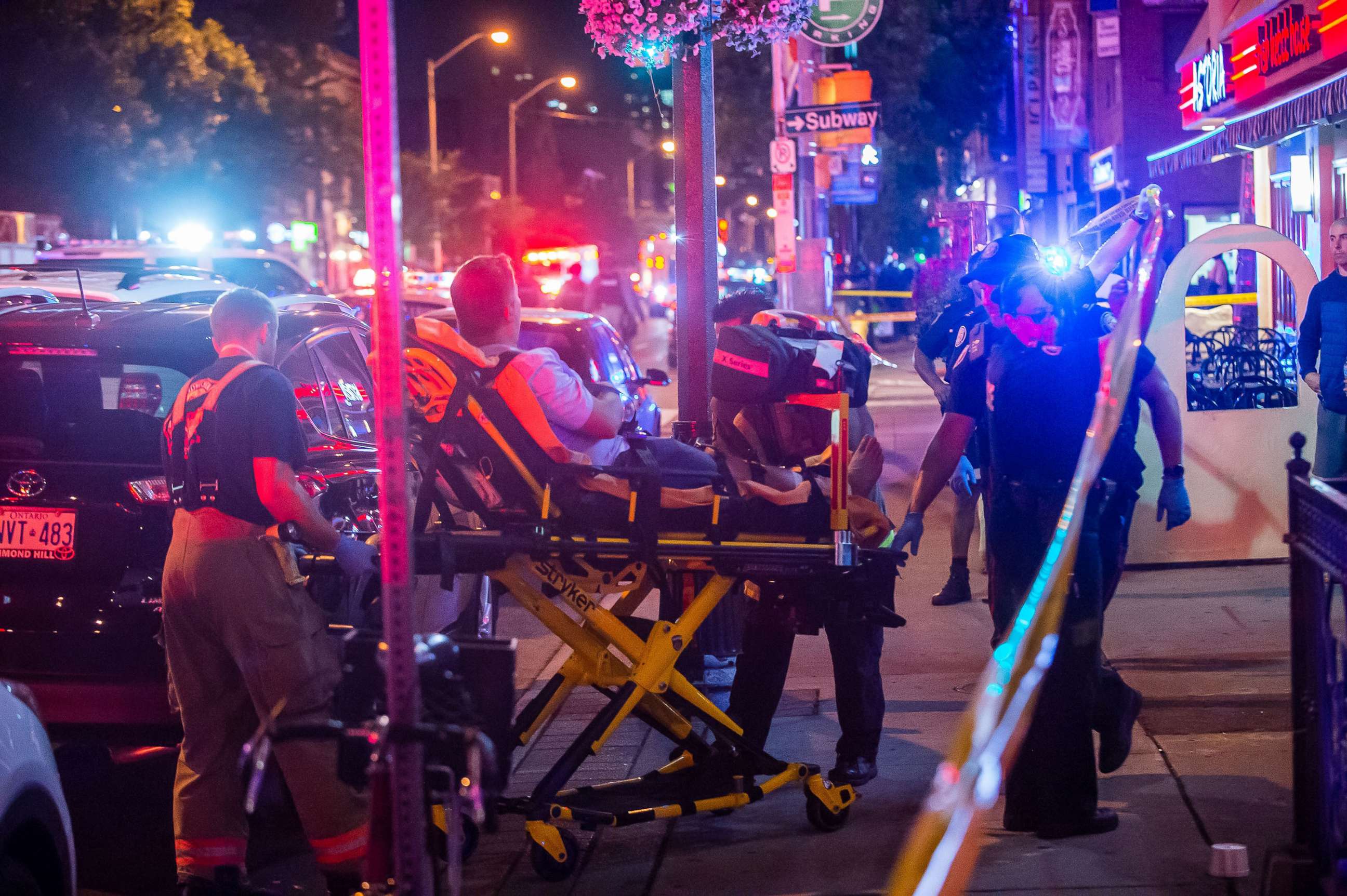 PHOTO: A man is transported in a stretcher after a shooting in Toronto on the evening of July 22, 2018.