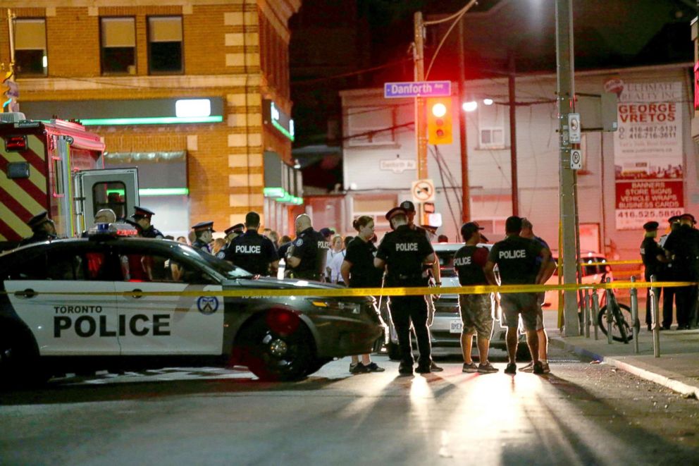   PHOTO: Police are seen near the scene of a mbad shooting in Toronto, July 22, 2018. 