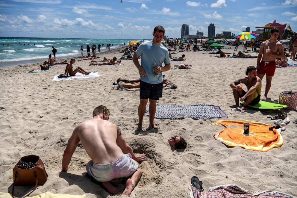 PHOTO: Tourists relax on the beach in Miami Beach, Florida, on March 18, 2020.