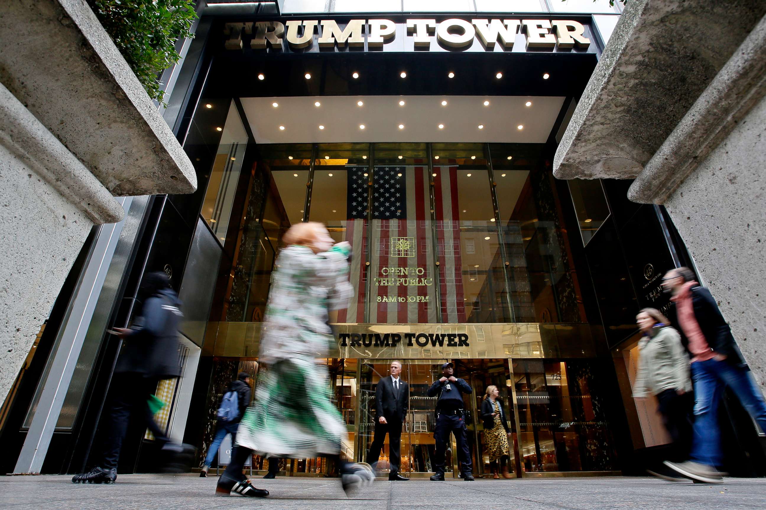 PHOTO: People make their way past the Trump Tower, Oct. 24, 2022, in New York.