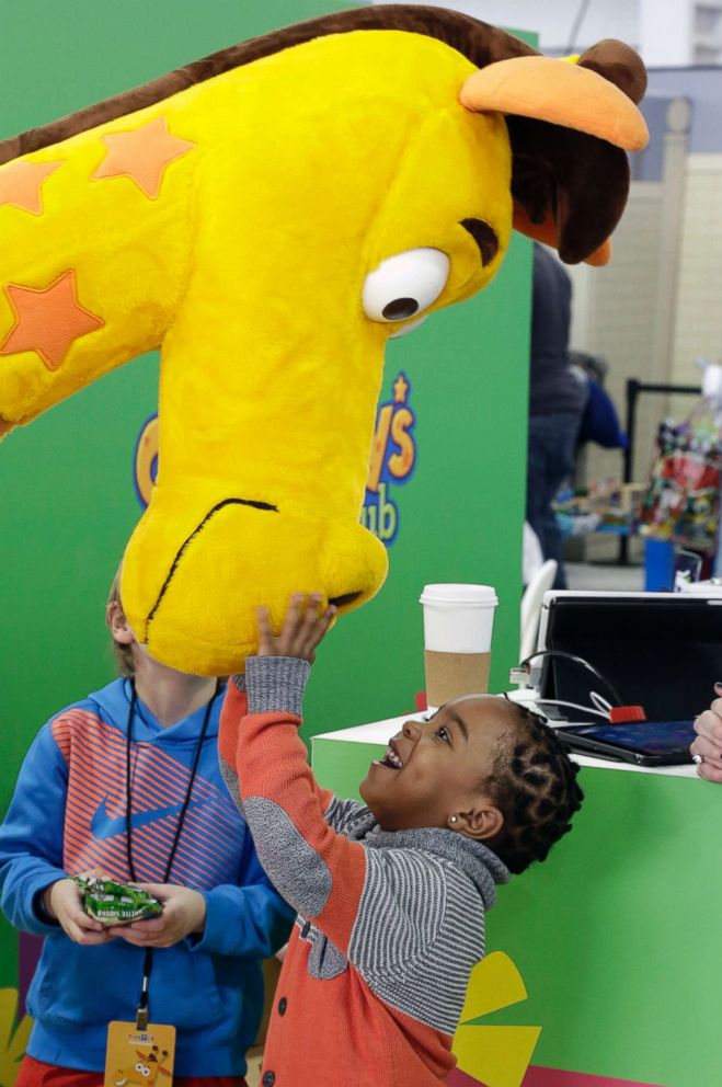 PHOTO: Jahmae Evans, 4, talks to Geoffrey the Giraffe at Toy Fair in New York, in this Feb. 14, 2016 file photo.