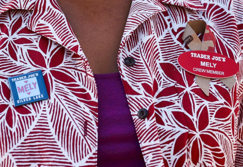 PHOTO: Kenya Friend-Daniel shows buttons worn by store staff in memorial to store manager Melyda Corado at Trader Joe's market in the Silver Lake district of Los Angeles, Aug. 2, 2018.