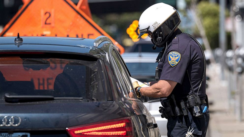 PHOTO: A City of San Francisco police officer issues a citation during a traffic stop in San Francisco, June 16, 2020. 