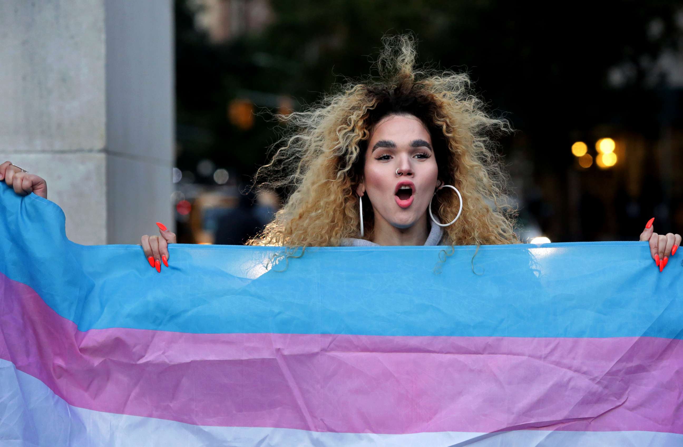 PHOTO: Morgin Dupont, 25, a woman of trans experience, holds up the flag for Transgender and Gender Noncomforming people at a rally for LGBTQI+ rights at Washington Square Park on October 21, 2018 in New York City.