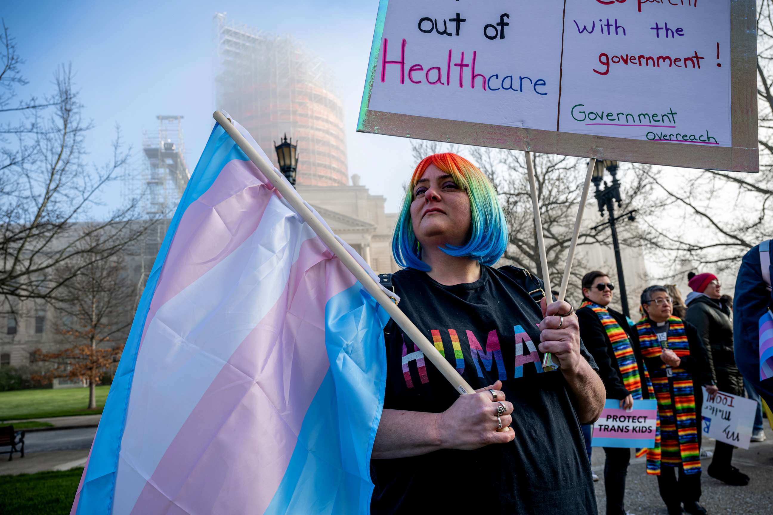 PHOTO: Sarah Newton stands with a trans pride flag during a rally to protest the passing of SB 150 on March 29, 2023 at the Kentucky State Capitol in Frankfort, Kentucky.