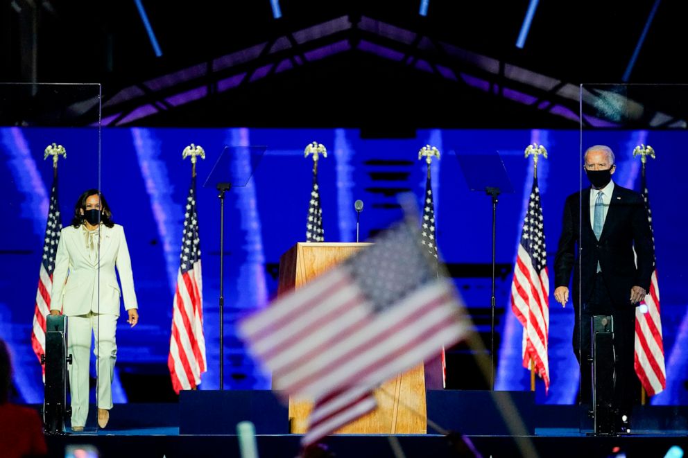 PHOTO: Vice President-elect Kamala Harris  and President-elect Joe Biden stand onstage after being declared the winners of the presidential election in Wilmington, Del., November 7, 2020.