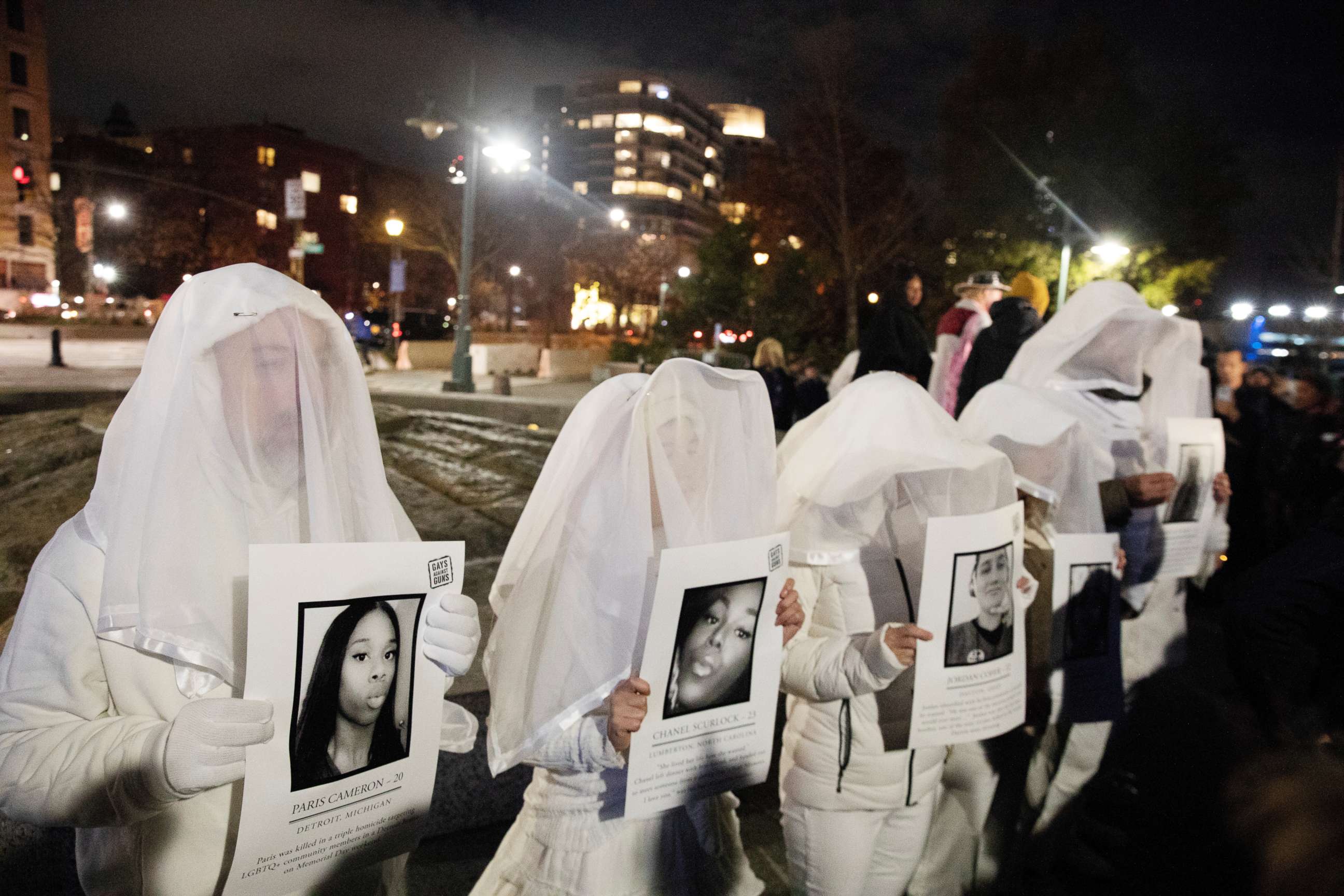 PHOTO: Activists dress in white and hold images of slain members of the LGBTQ community during a demonstration to commemorate Transgender Day of Remembrance in New York, Nov. 20, 2019.