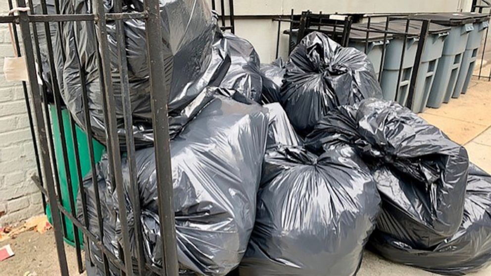 PHOTO: Trash cans sit outside a residential building in New York City, July 29, 2022.