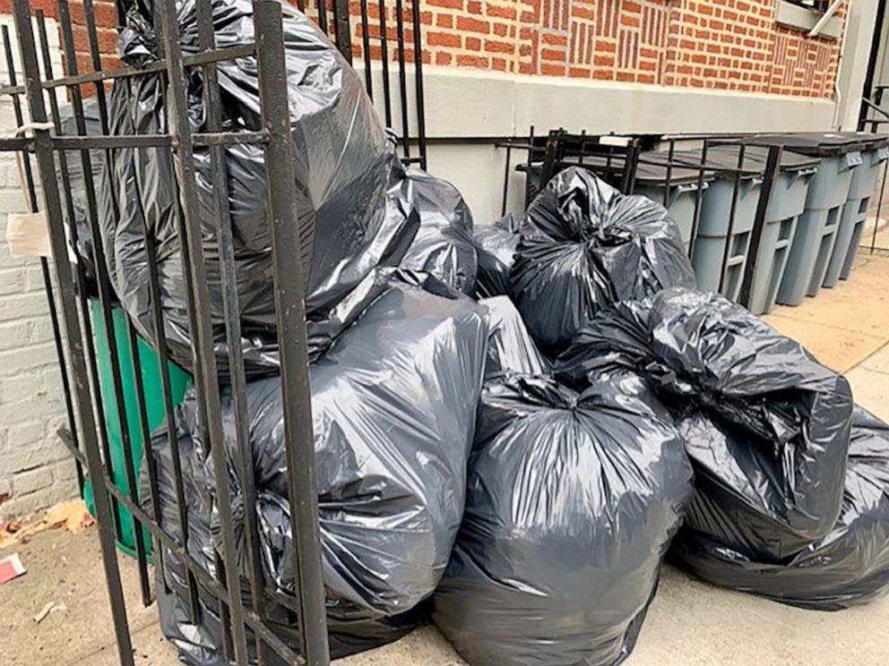 PHOTO: Trash cans sit outside a residential building in New York City, July 29, 2022.