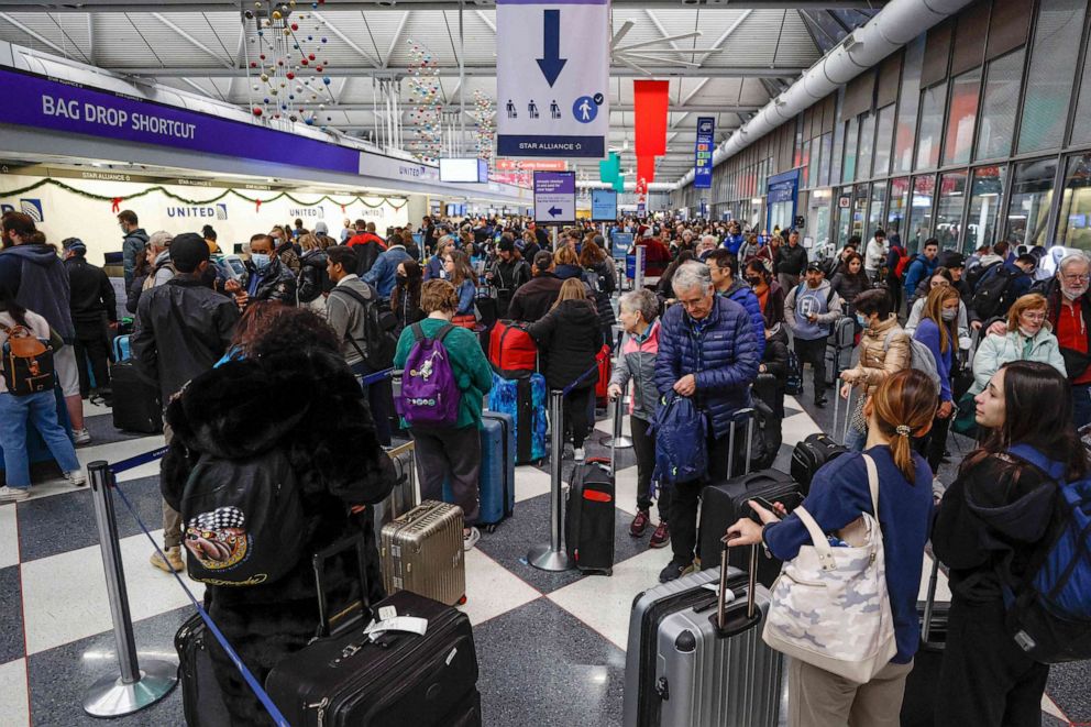 PHOTO: Travelers arrive for their flights at the United Airlines Terminal 1 ahead of the Christmas Holiday, at O'Hare International Airport, Dec. 22, 2022, in Chicago.