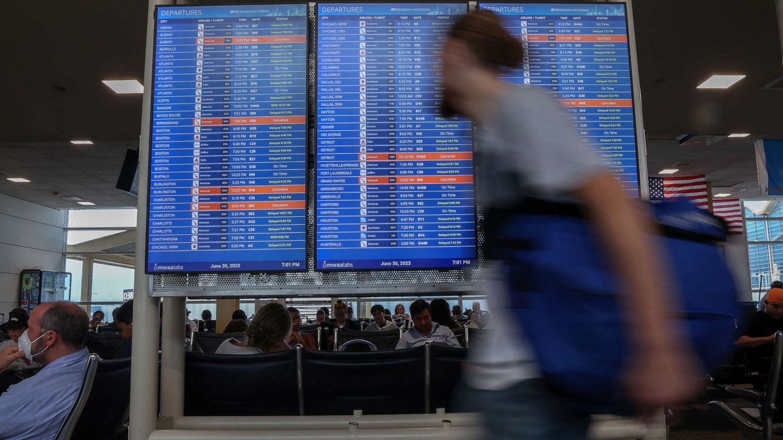 PHOTO: Travelers check the status of their flights ahead of the July 4 holiday weekend at Ronald Reagan Washington National Airport in Arlington, Va., June 30, 2023.