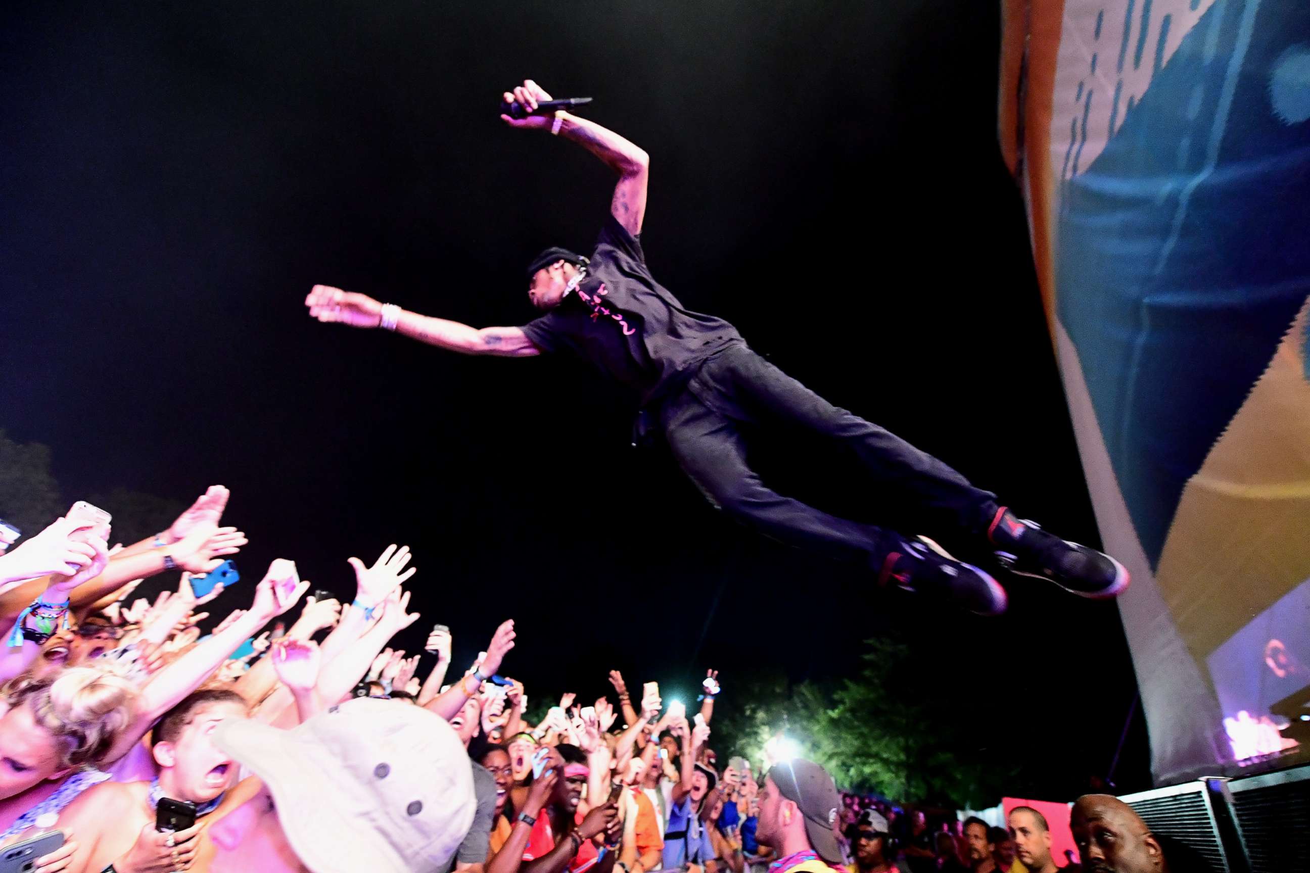 PHOTO: Travis Scott jumps into the audience while performing on Day 4 of the 2017 Bonnaroo Arts And Music Festival, June 11, 2017, in Manchester, Tenn.