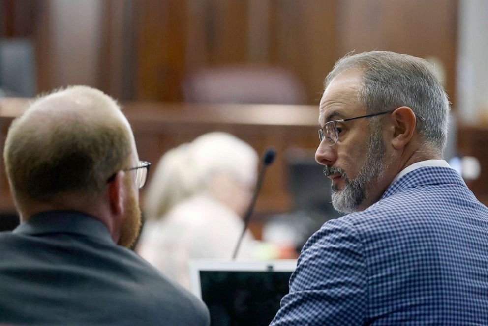 PHOTO: Travis McMichael speaks with defense attorney Jason Sheffield during opening statements in the trial of Ahmaud Arbery's killers at the Gwynn County Superior Court on Nov. 5, 2021 in Brunswick, Ga. 