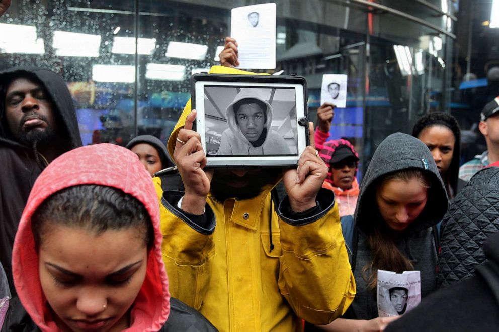 PHOTO: In this March 23, 2012, file photo, Jayve Montgomery holds up an electronic picture of Trayvon Martin on an iPad during a march and rally in Chicago in support of the 17-year-old's family.