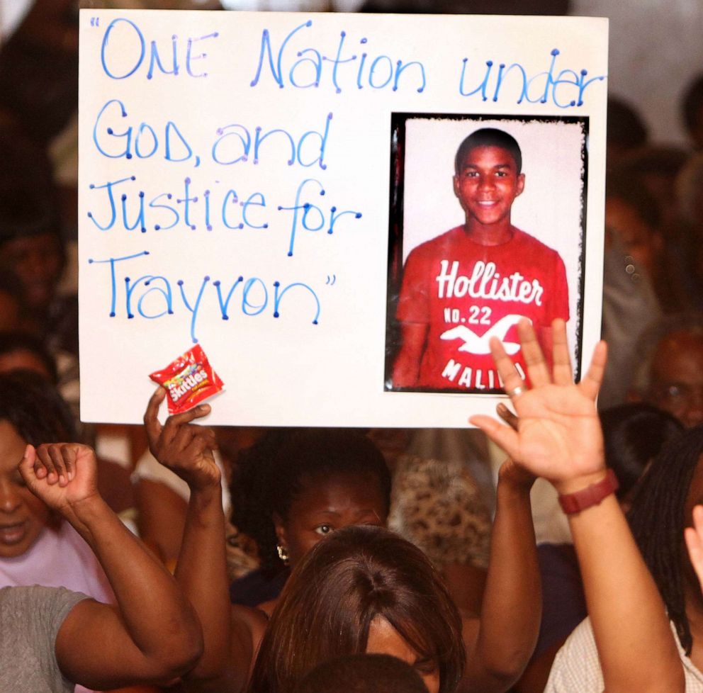 PHOTO: In this March 20, 2012, file photo, a protester holds a sign inside the Allen Chapel AME Church in Sanford, Fla. A meeting hosted by the NAACP was held to address community concerns after the shooting of Trayvon Martin.