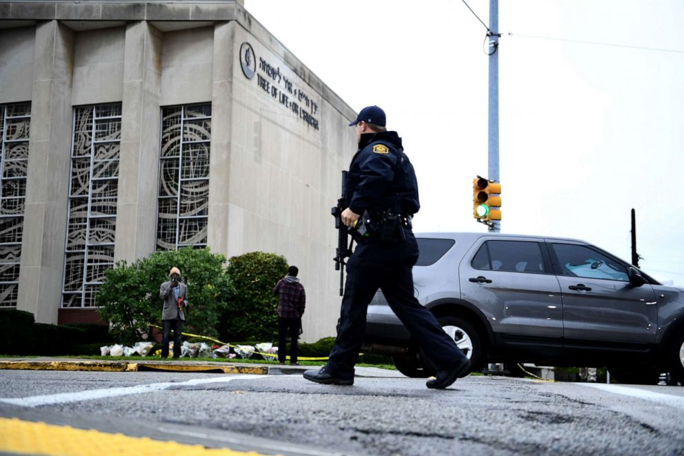 PHOTO: A member of the police crosses the street on October 28, 2018 outside the Tree of Life Synagogue after a shooting there left 11 people dead in the Squirrel Hill neighborhood of Pittsburgh on Oct. 27, 2018.